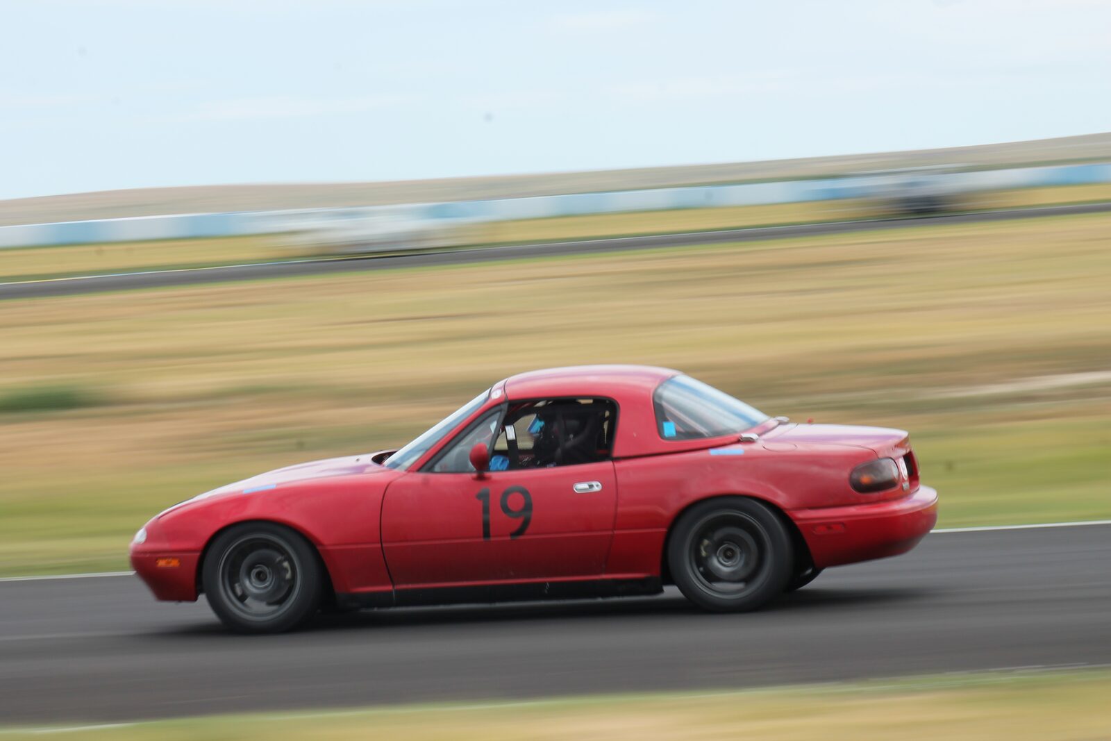 The same car at speed, panned against a blurred background