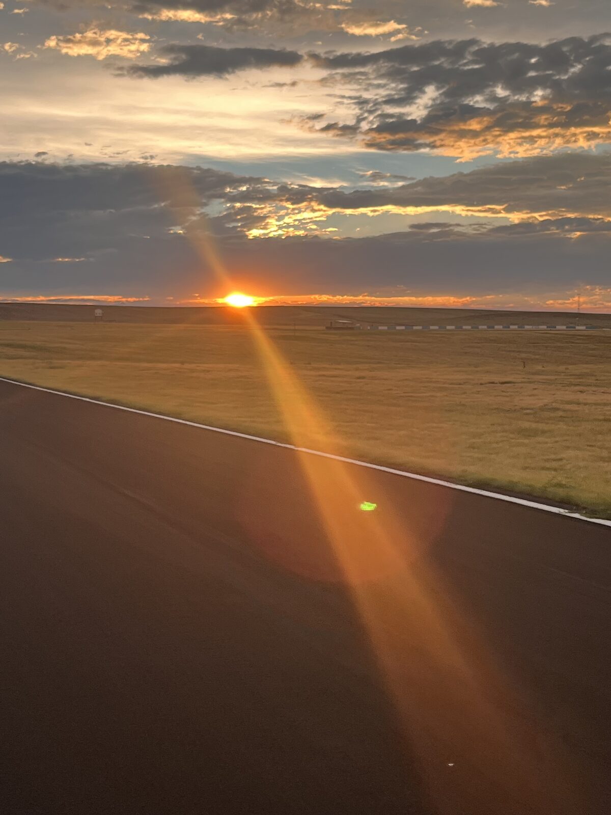 The sun low over an empty racetrack